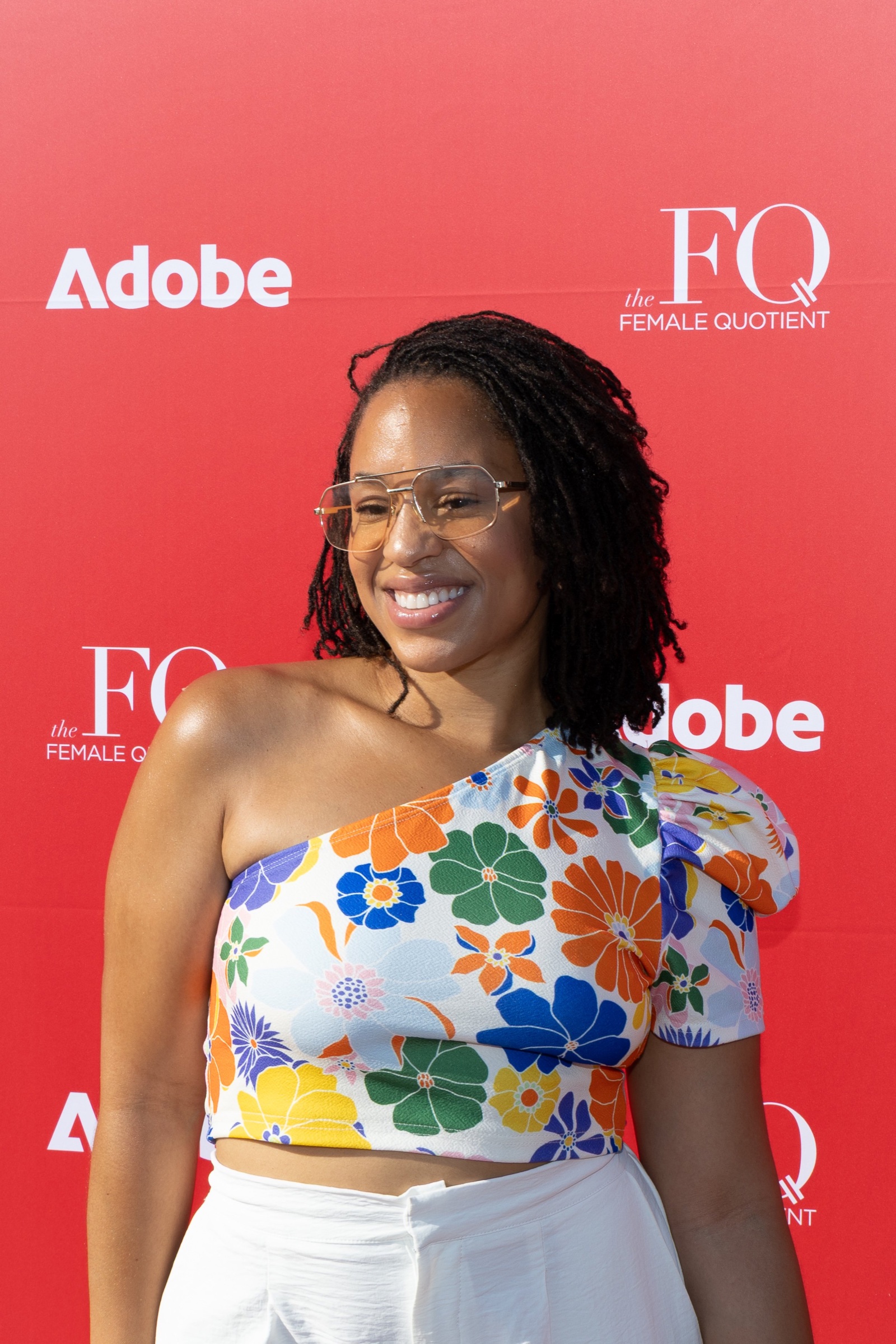 Guest portrait in front of the Adobe and Female Quotient backdrop