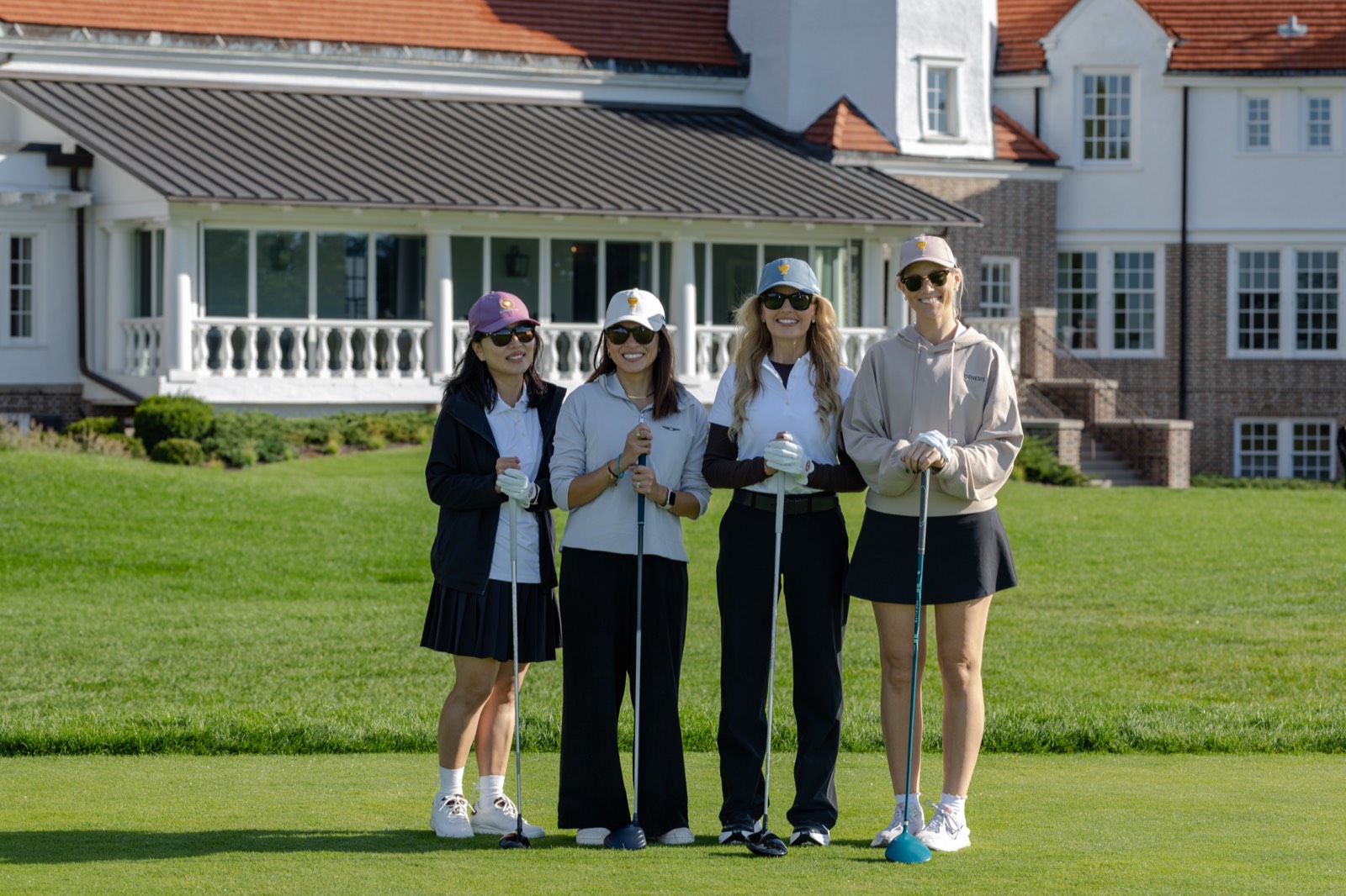 Four Genesis Presidents Cup guests with their drivers on the first tee at Chicago Golf Club