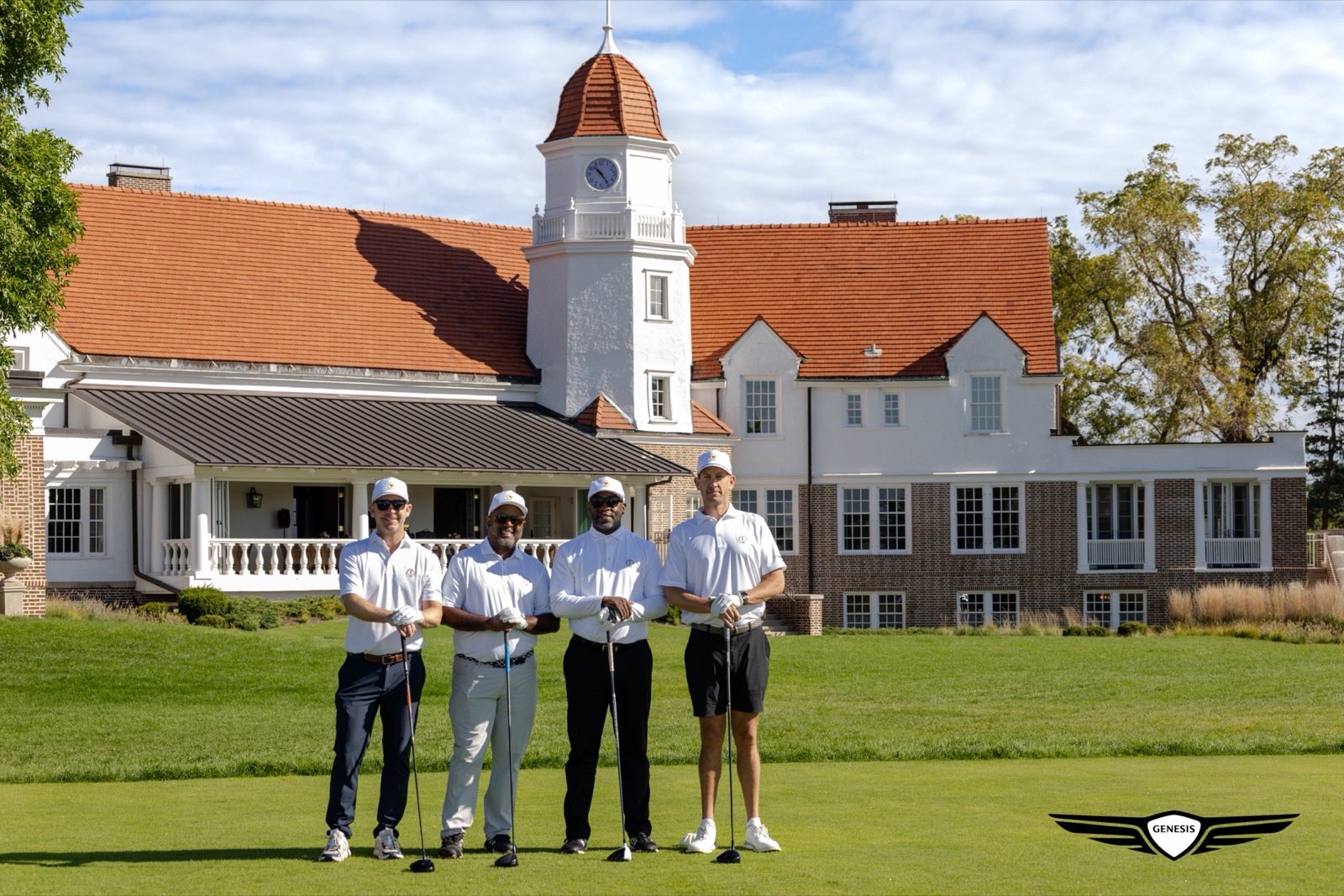 Four Genesis Presidents Cup guests standing in front of the Chicago Golf Club clubhouse