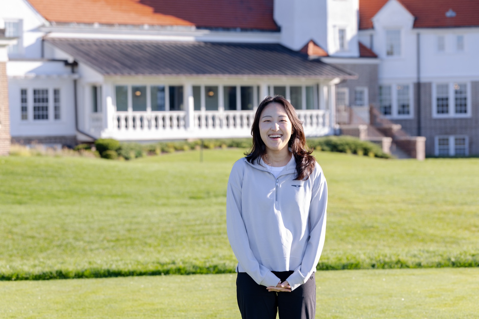 A smiling Genesis Presidents Cup guest on the tee at Chicago Golf Club