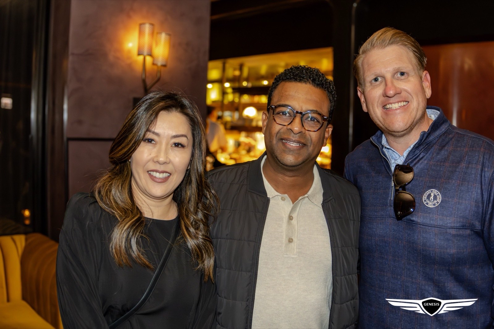 Three Genesis Presidents Cup guests together at the bar