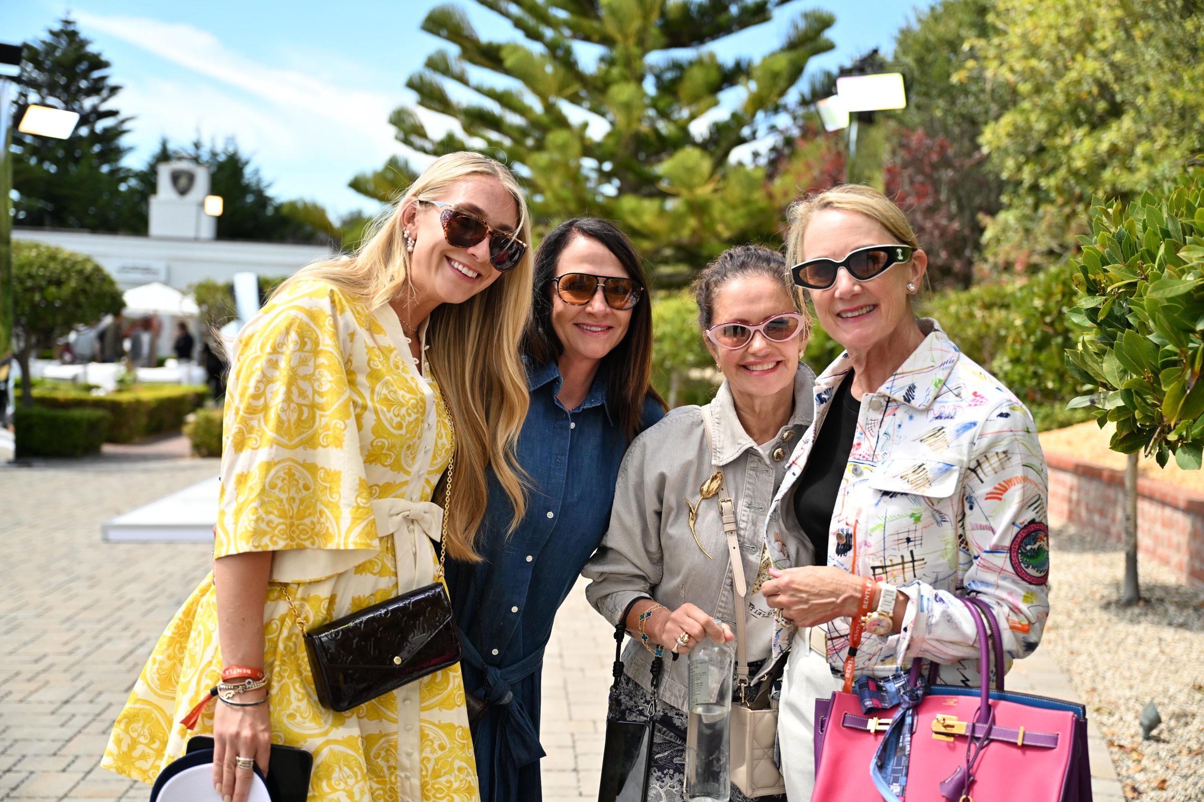 4 guests in sunglasses posing together outside Lamborghini Villa during Monterey Car Week