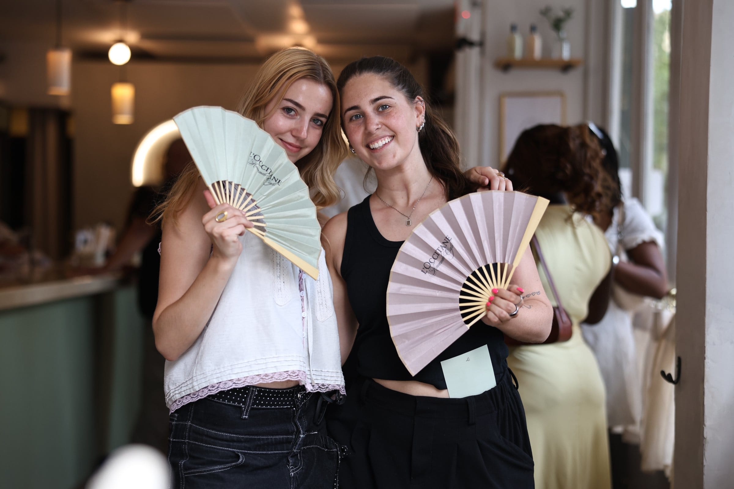 L'OCCITANE Amande Cafe guests with branded fans