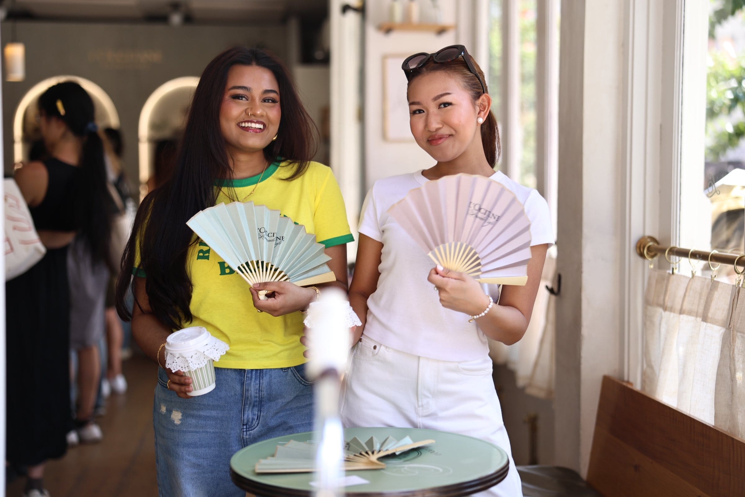 L'OCCITANE Amande Cafe public guests with branded fans