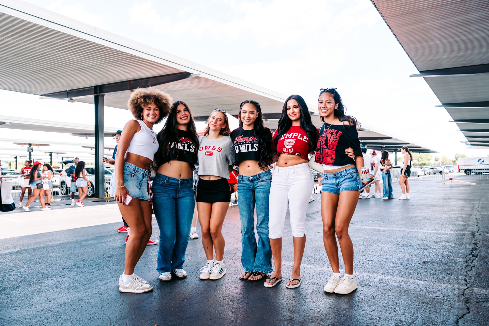 Six Temple students posing together in the tailgate lot