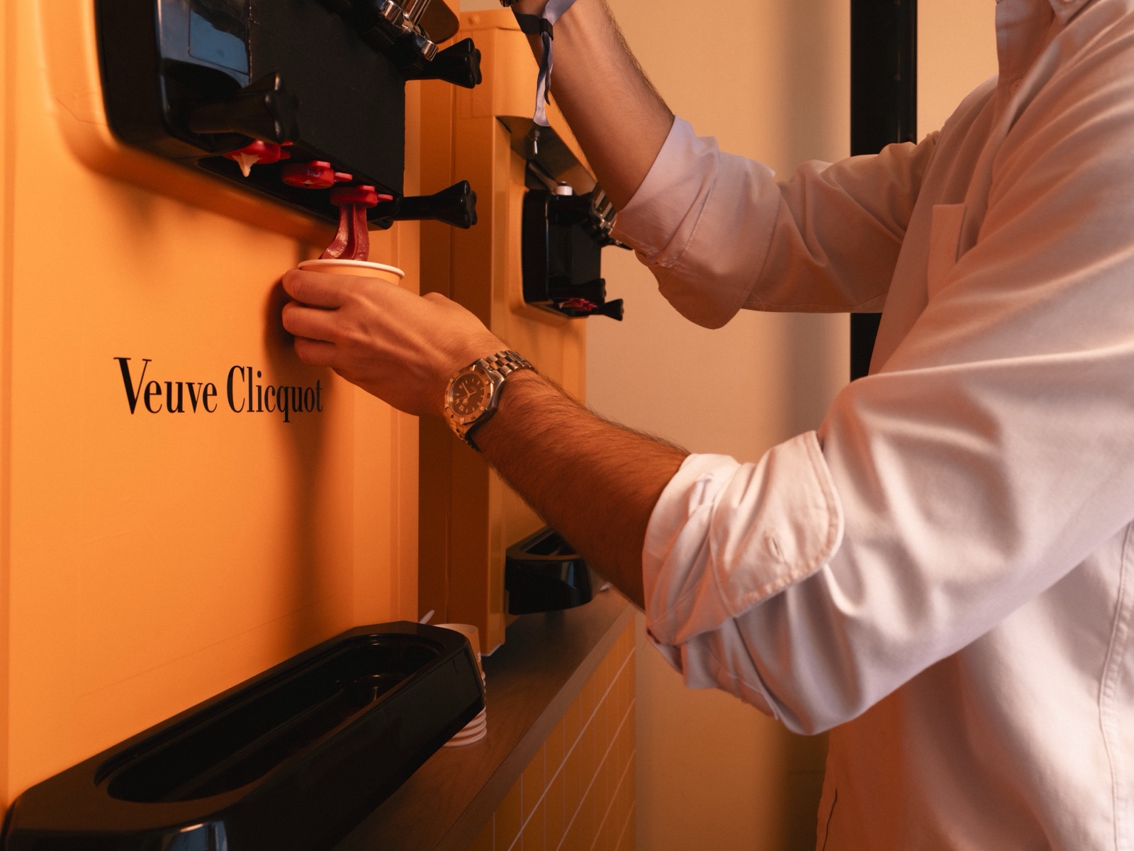 Soft serve being poured into a cup at a Veuve Clicquot branded counter
