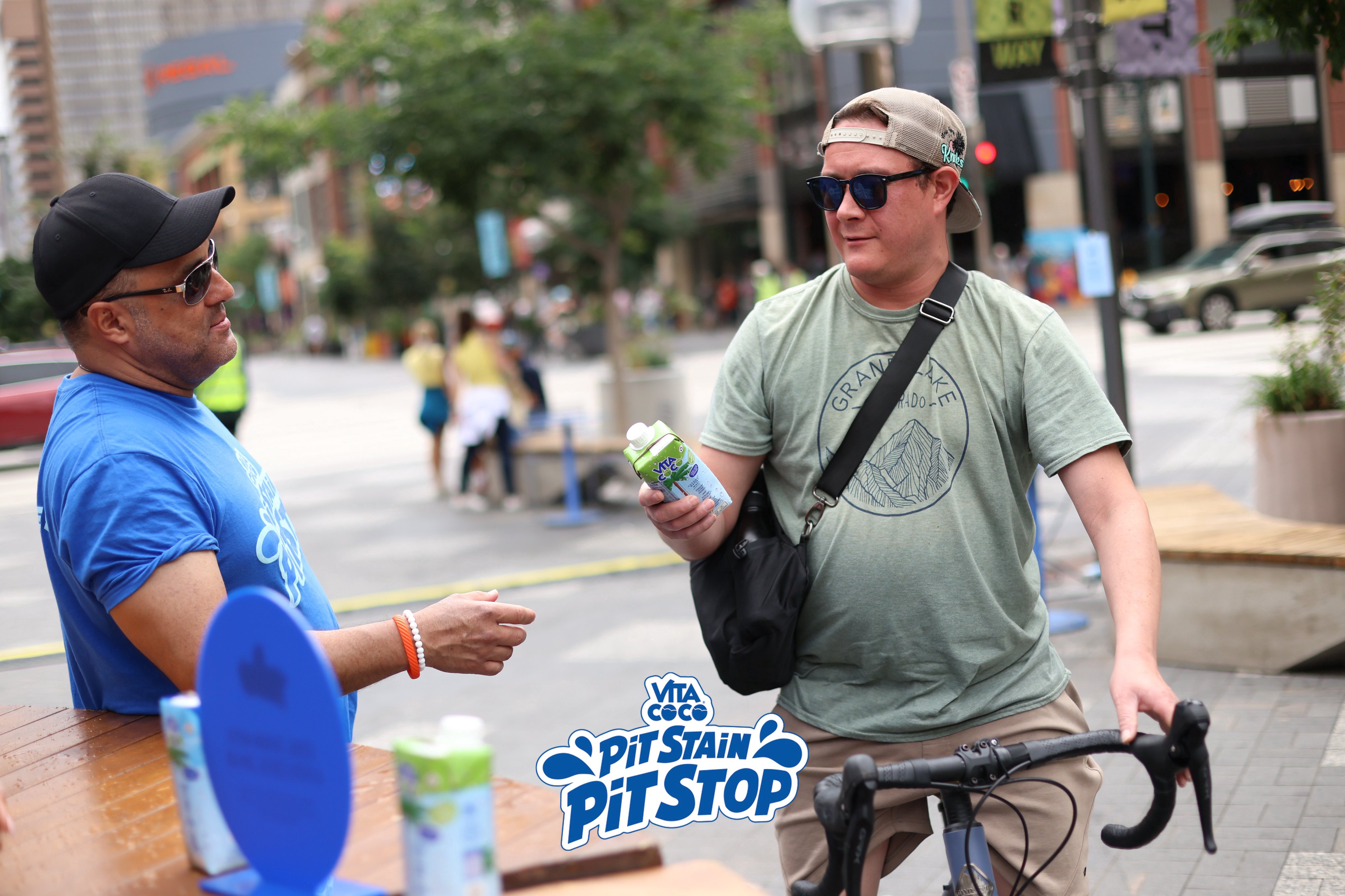A guest receiving a Vita Coco sample while passing through the activation