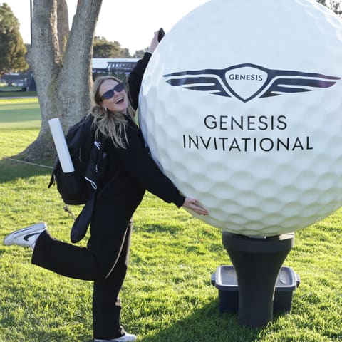 Guest posing with a giant golf ball at the Genesis Invitational